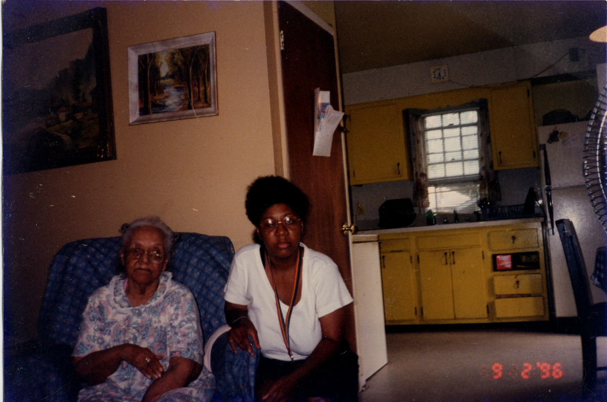 Donor's mother (Gladys Lillian Haliburton) sitting with granddaughter Osceola in a house.