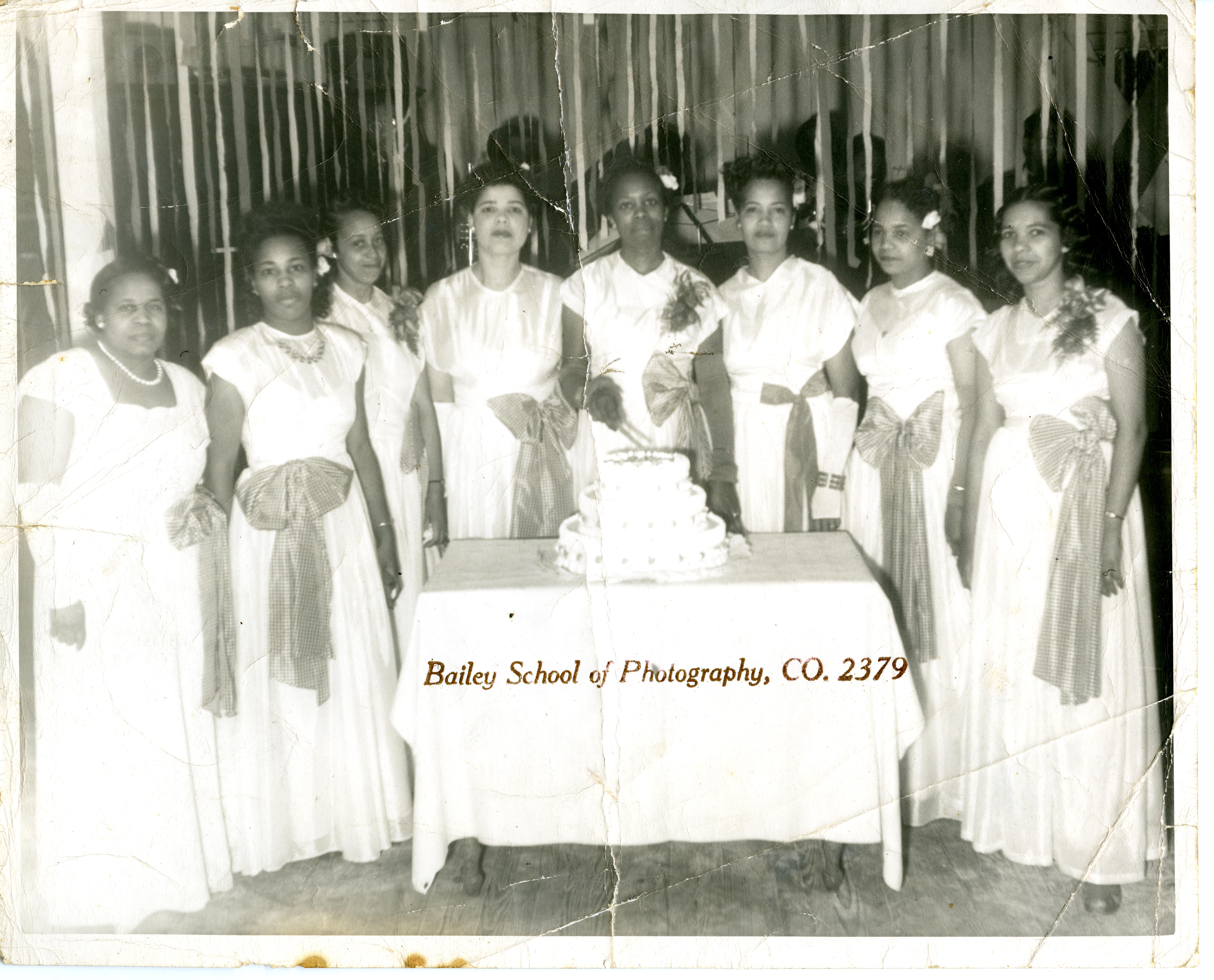 Members of Duchess social club with cake