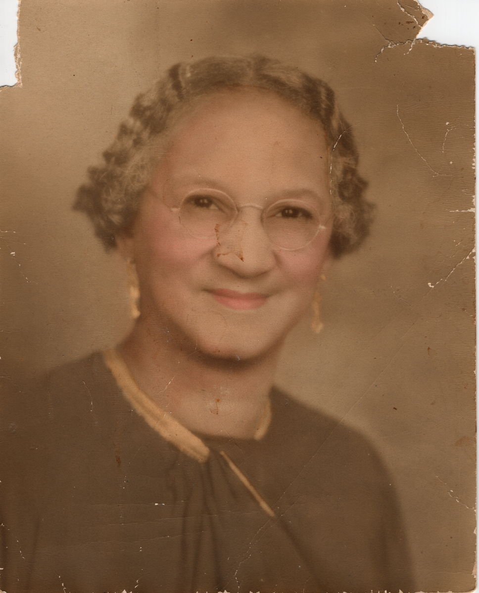 Large photo of Fanny, donor's grandmother. Sepia, with coloring added. From early 1900s.