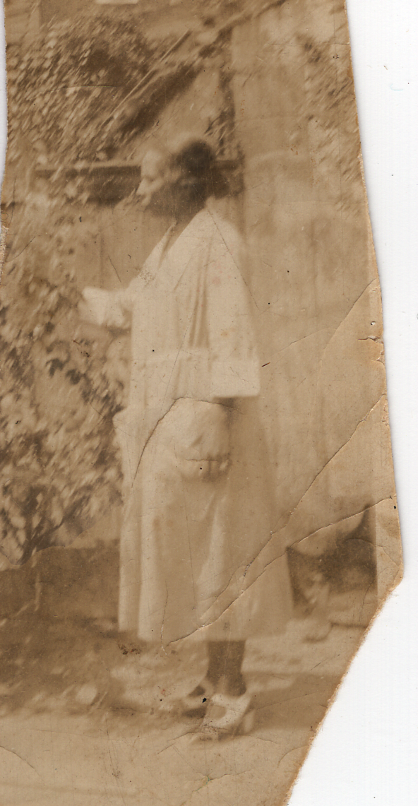 Sepia photo of Gladys's friend in a garden. 